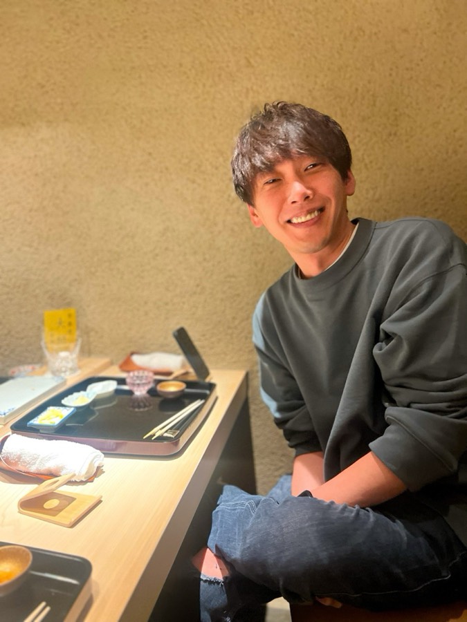 お店のカウンターで笑う陰山秀信